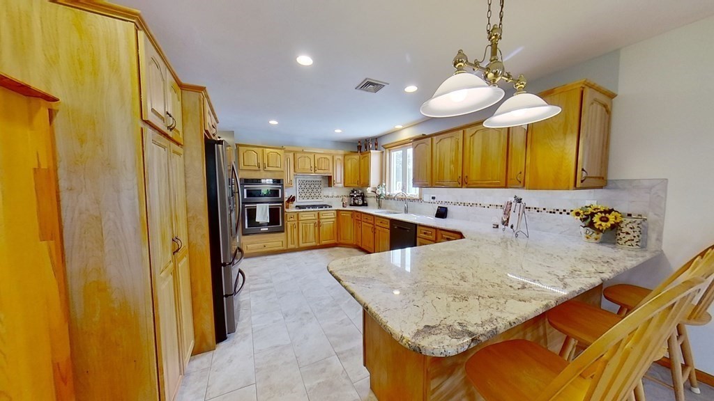 35 Brownfield Drive Bridgewater, MA 02324 - Photo 4 of 42 a view of a kitchen with a sink and a refrigerator