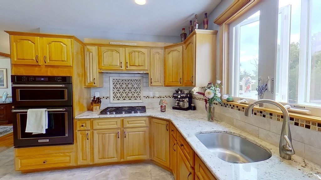 35 Brownfield Drive Bridgewater, MA 02324 - Photo 5 of 42 a kitchen with stainless steel appliances a sink a stove and a microwave