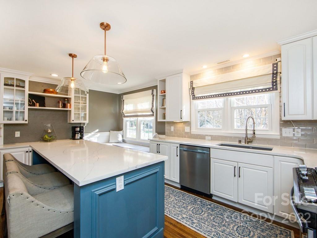 1000 Braeburn Road Charlotte, NC 28211 - Photo 14 of 48 a kitchen with a sink a center island and some windows