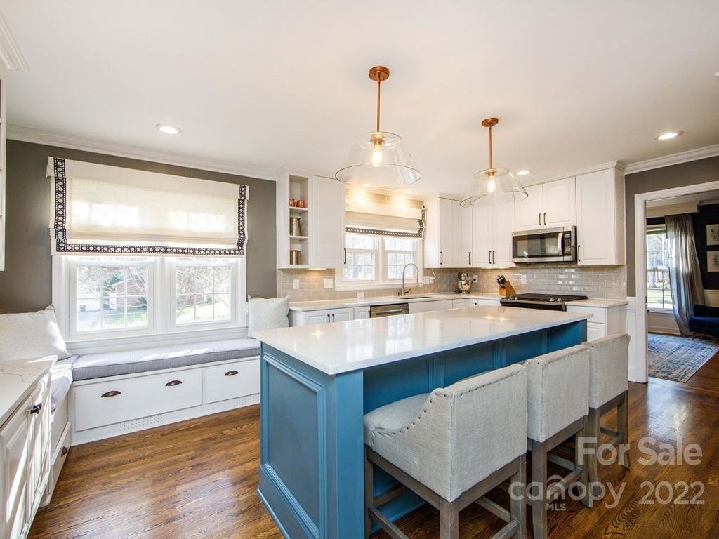 1000 Braeburn Road Charlotte, NC 28211 - Photo 16 of 48 a kitchen with stainless steel appliances granite countertop a sink stove and refrigerator