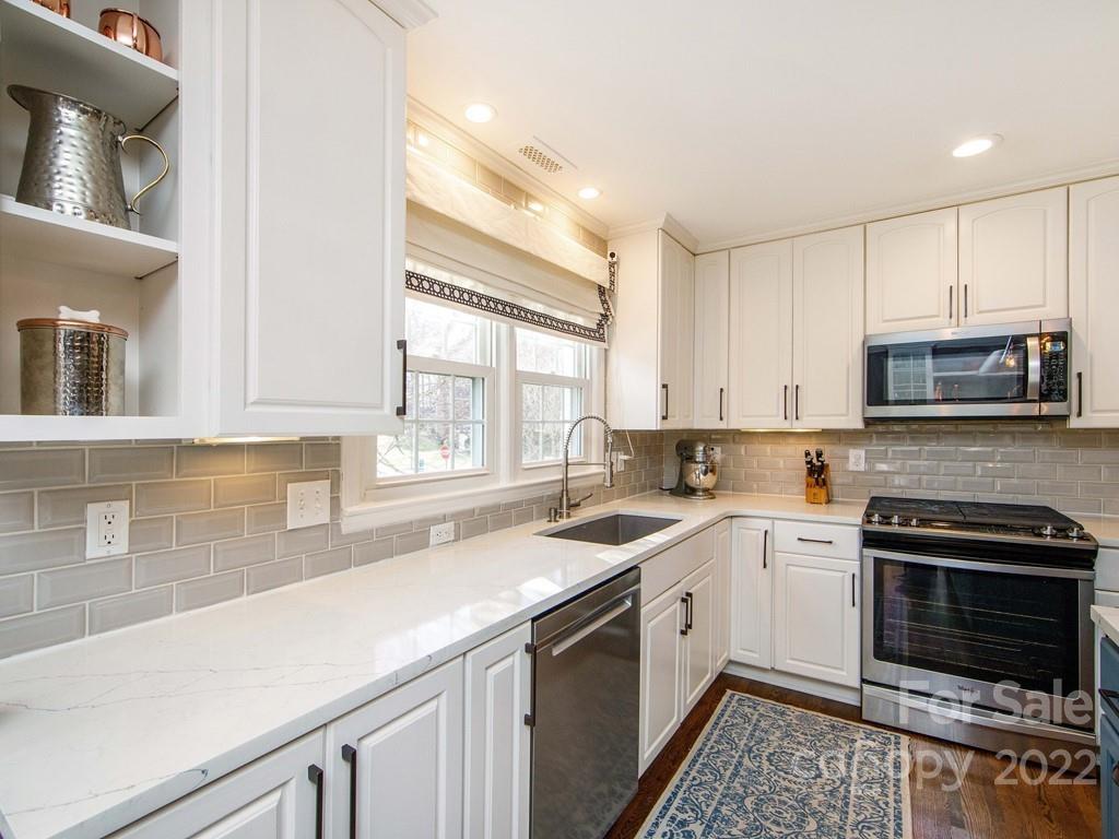 1000 Braeburn Road Charlotte, NC 28211 - Photo 18 of 48 a kitchen with a sink stove top oven and cabinets