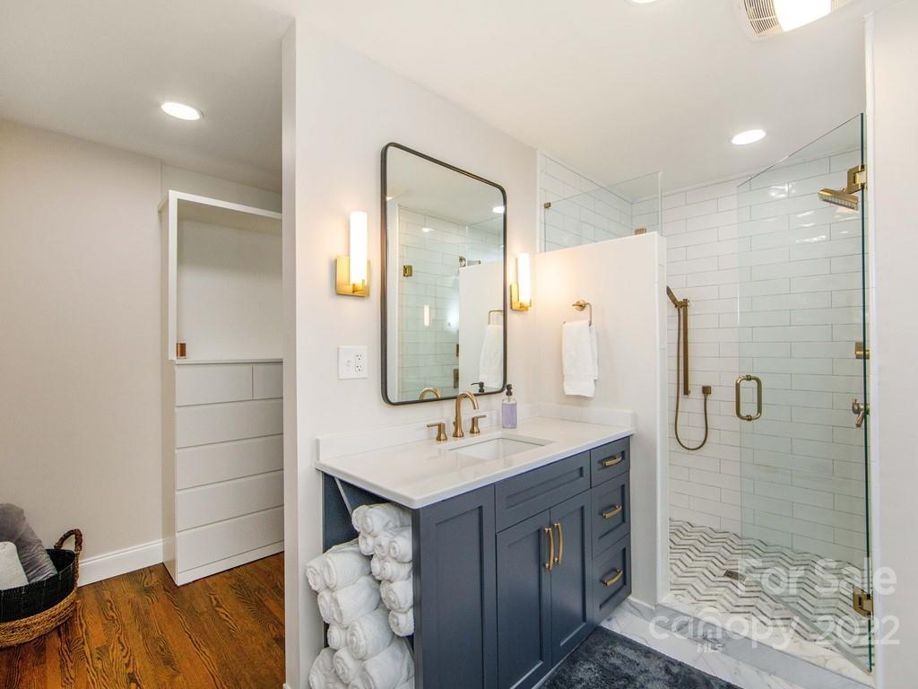 1000 Braeburn Road Charlotte, NC 28211 - Photo 31 of 48 a bathroom with a shower sink and mirror