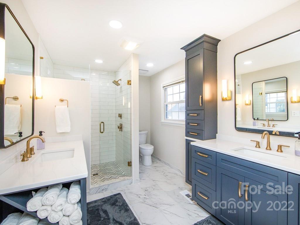 1000 Braeburn Road Charlotte, NC 28211 - Photo 32 of 48 a bathroom with a sink double vanity granite tub and shower