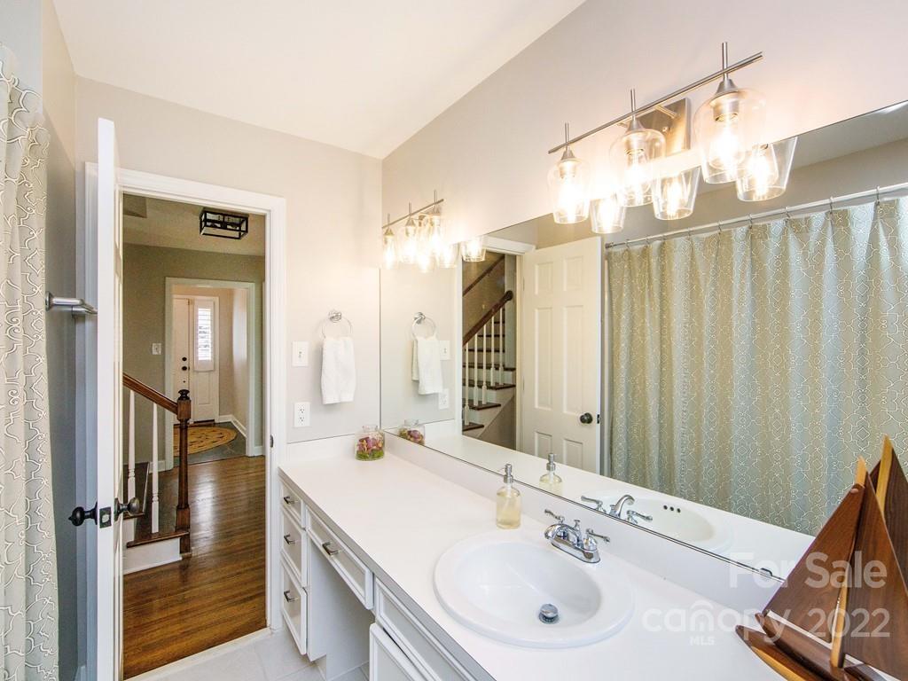 1000 Braeburn Road Charlotte, NC 28211 - Photo 34 of 48 a bathroom with a double vanity sink and a mirror