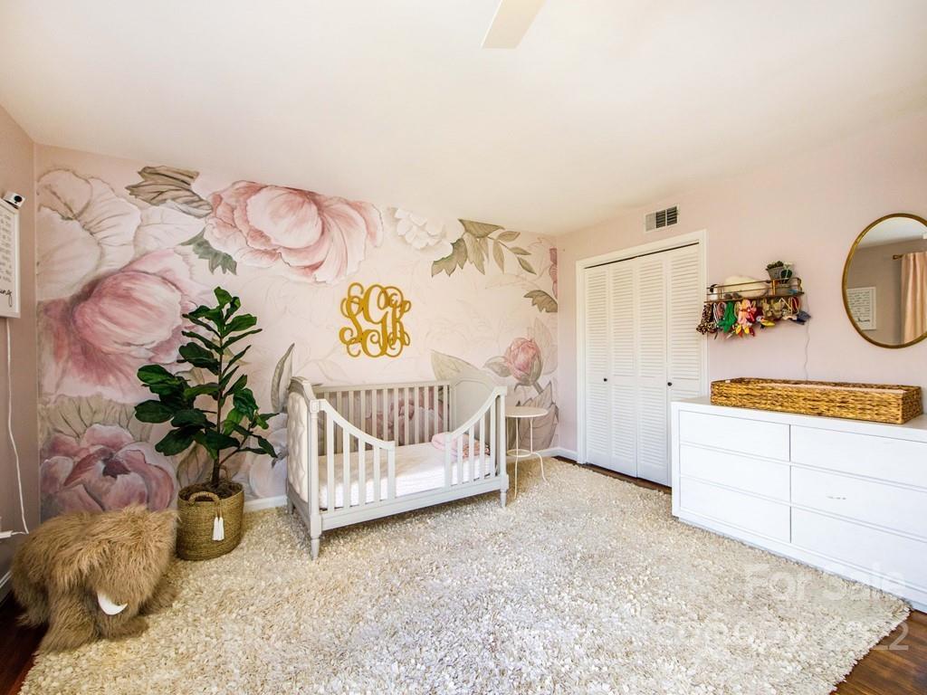 1000 Braeburn Road Charlotte, NC 28211 - Photo 37 of 48 a bedroom with furniture and a potted plant