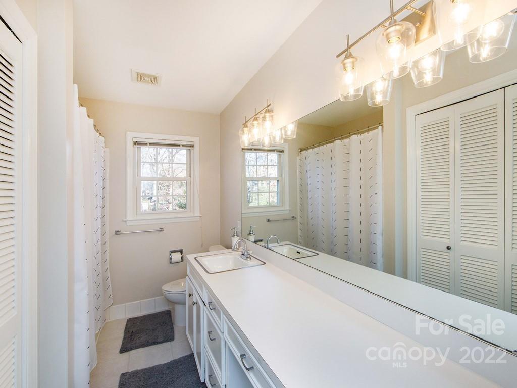 1000 Braeburn Road Charlotte, NC 28211 - Photo 38 of 48 a spacious bathroom with a sink mirror and a shower