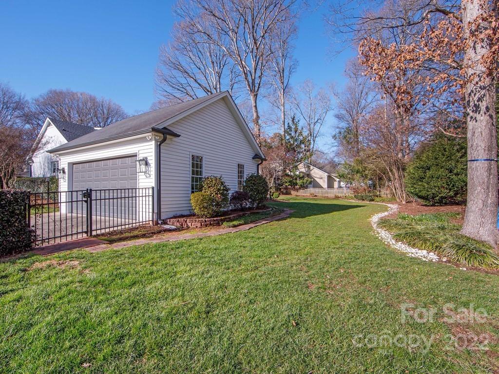 1000 Braeburn Road Charlotte, NC 28211 - Photo 42 of 48 a view of a backyard with table and chairs and a fire pit