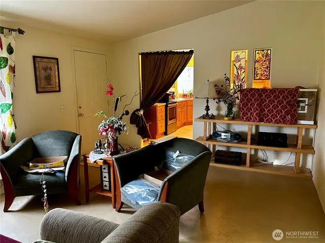 a living room with furniture rug and a window