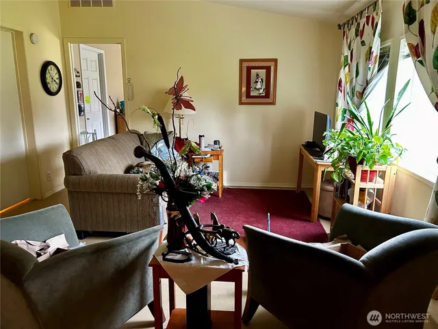 a living room with furniture and a potted plant