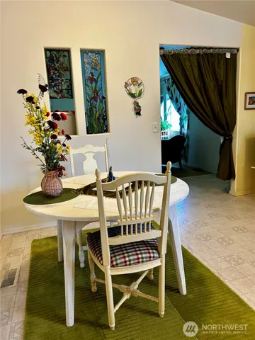 a dining room with furniture a rug and wooden floor