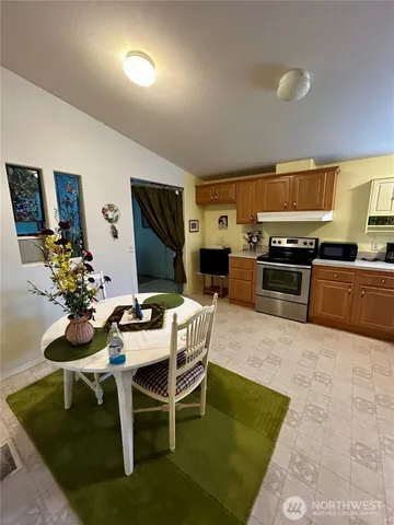 a kitchen with a dining table and chairs