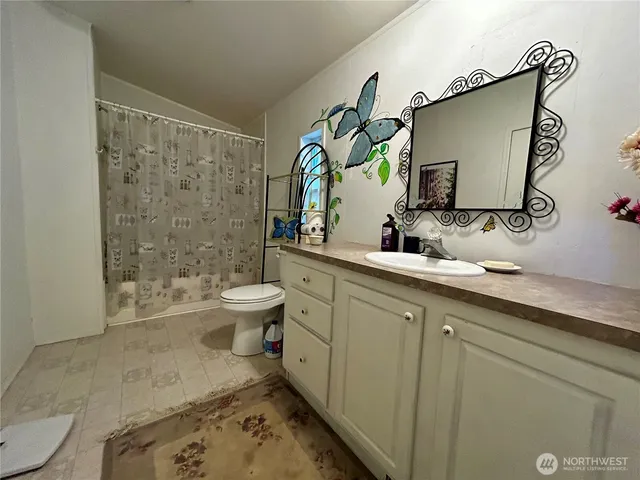 a bathroom with a sink mirror toilet and shower