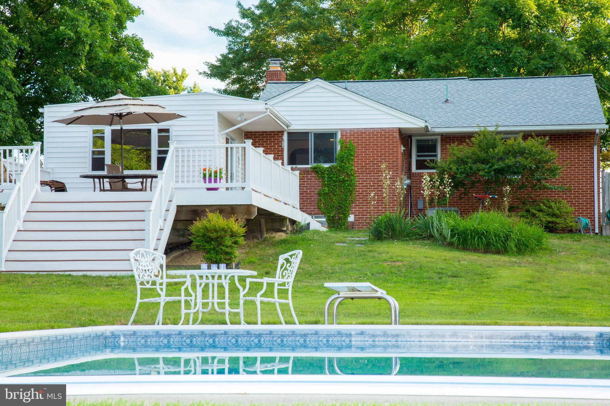 1722 Severn Road Severn, MD 21144 - Photo 31 of 45 a view of a white house with a yard table and chairs