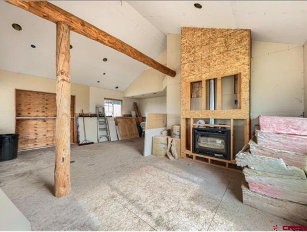 17081 2550th Road Cedaredge, CO 81413 - Photo 14 of 21 a living room with furniture a fireplace and kitchen view