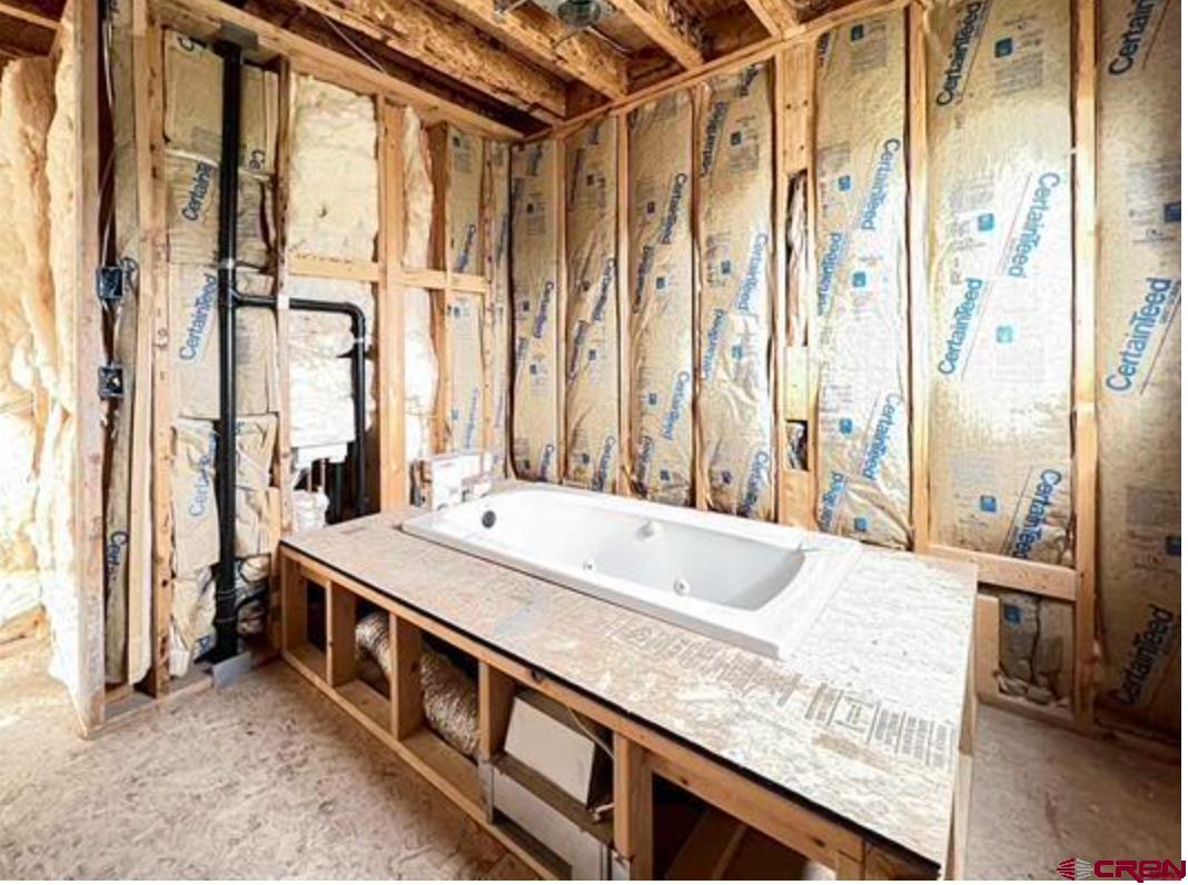 17081 2550th Road Cedaredge, CO 81413 - Photo 15 of 21 a spacious bathroom with a granite countertop double vanity and a large mirror