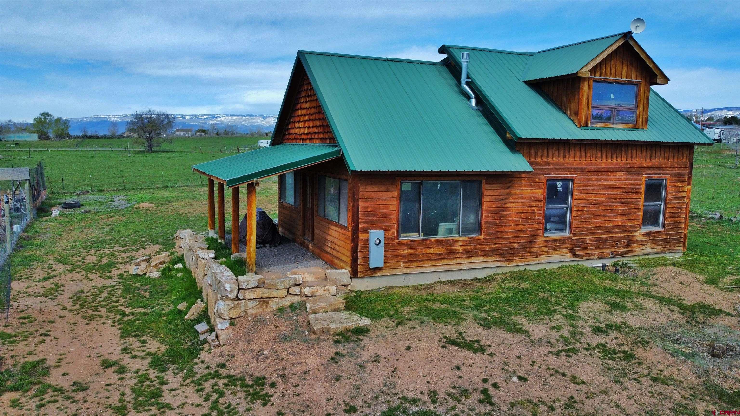 17081 2550th Road Cedaredge, CO 81413 - Photo 20 of 21 a front view of a house with garden