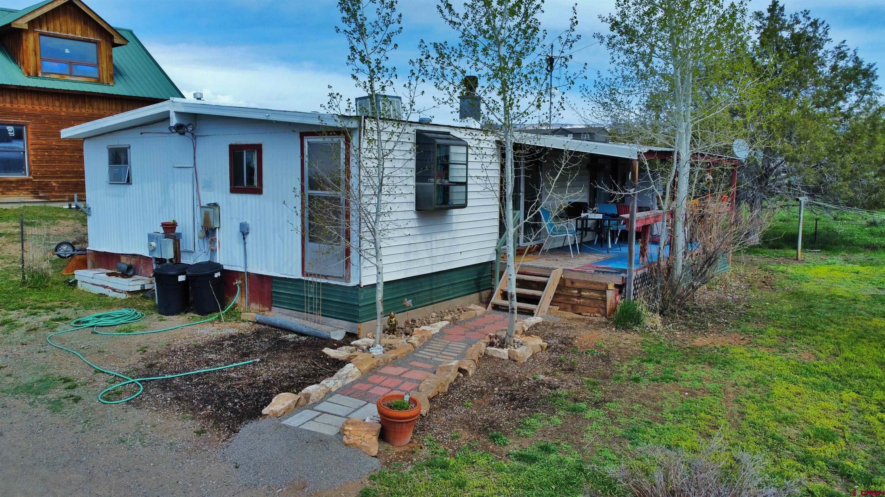 17081 2550th Road Cedaredge, CO 81413 - Photo 3 of 21 a view of a house with a yard and sitting area