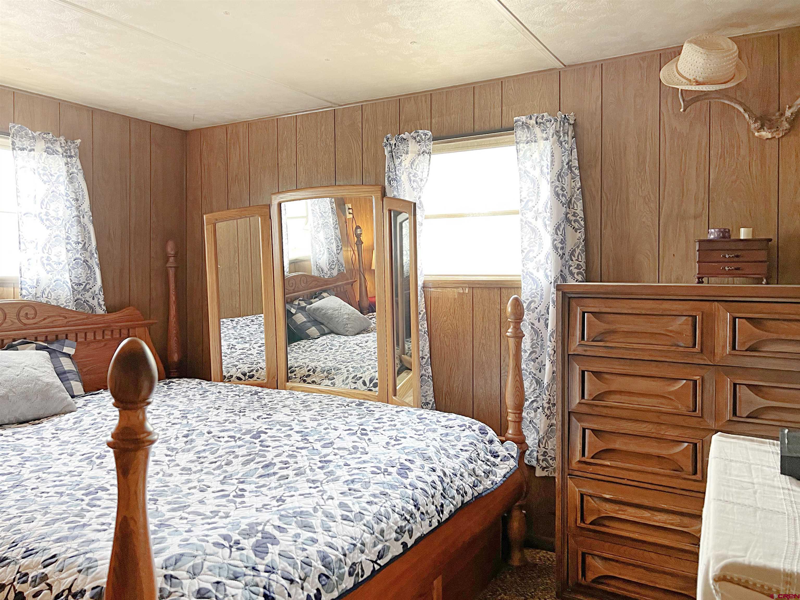 17081 2550th Road Cedaredge, CO 81413 - Photo 8 of 21 a bedroom with a bed next to a window with outer view