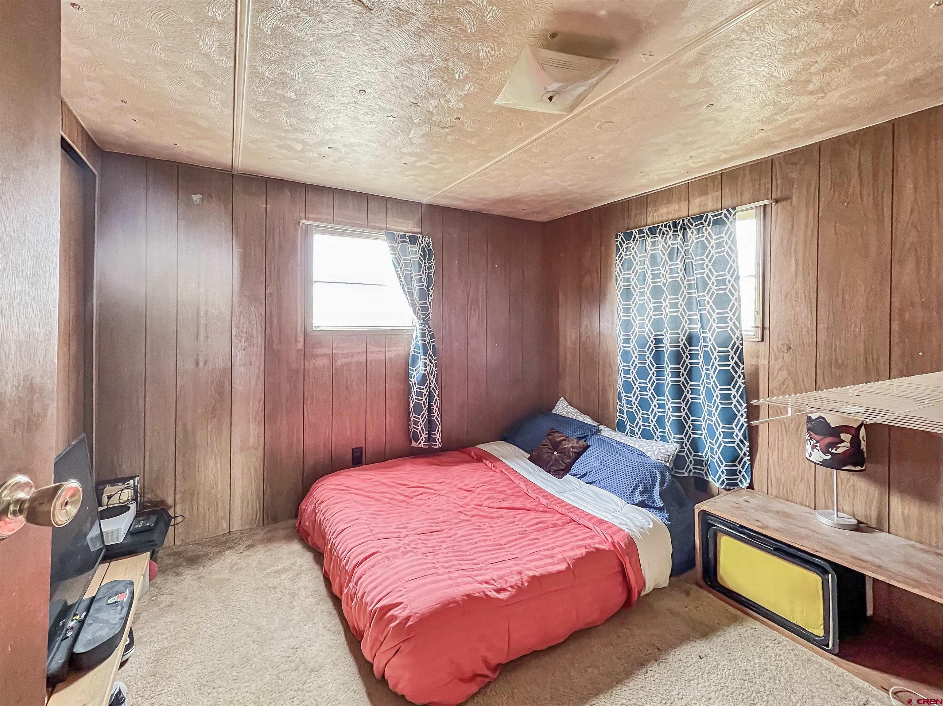 17081 2550th Road Cedaredge, CO 81413 - Photo 9 of 21 a bedroom with a bed and large window