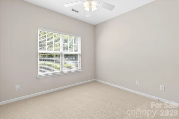 an empty room with a empty space and a ceiling fan