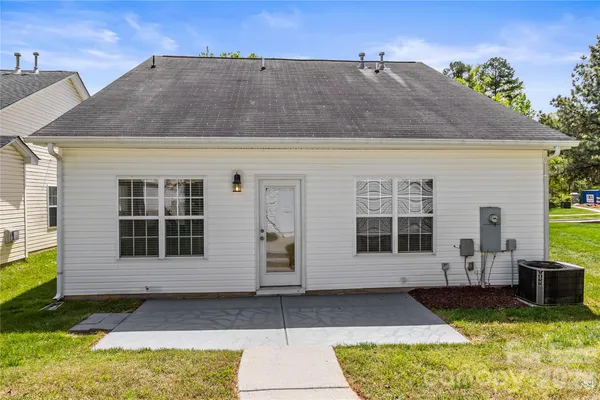 a view of a house with backyard and trees