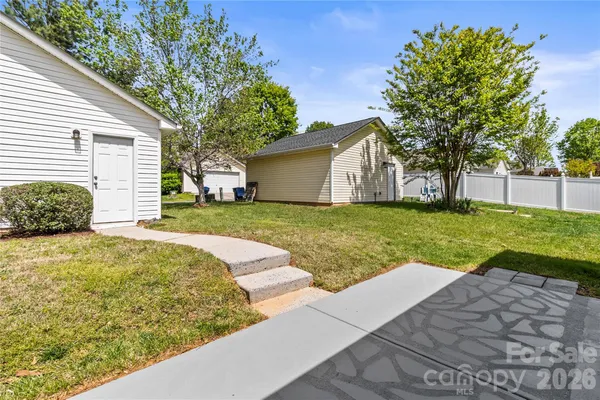 a view of a house with backyard and tree s