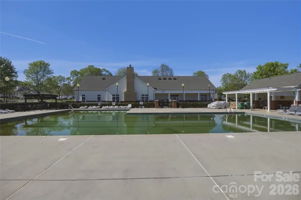 a view of chairs and table in patio with a yard