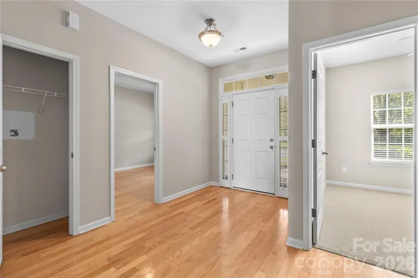 a view of hallway with wooden floor