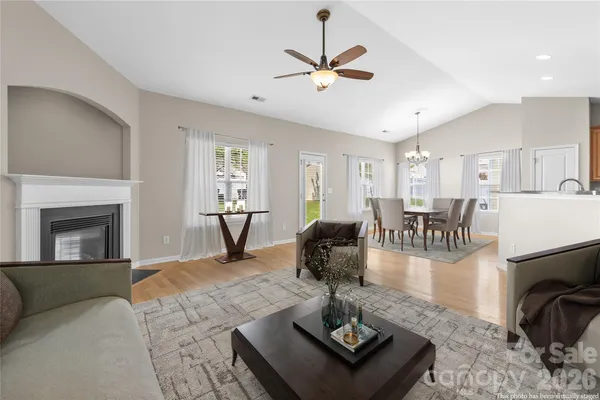 a living room with furniture and kitchen chandelier