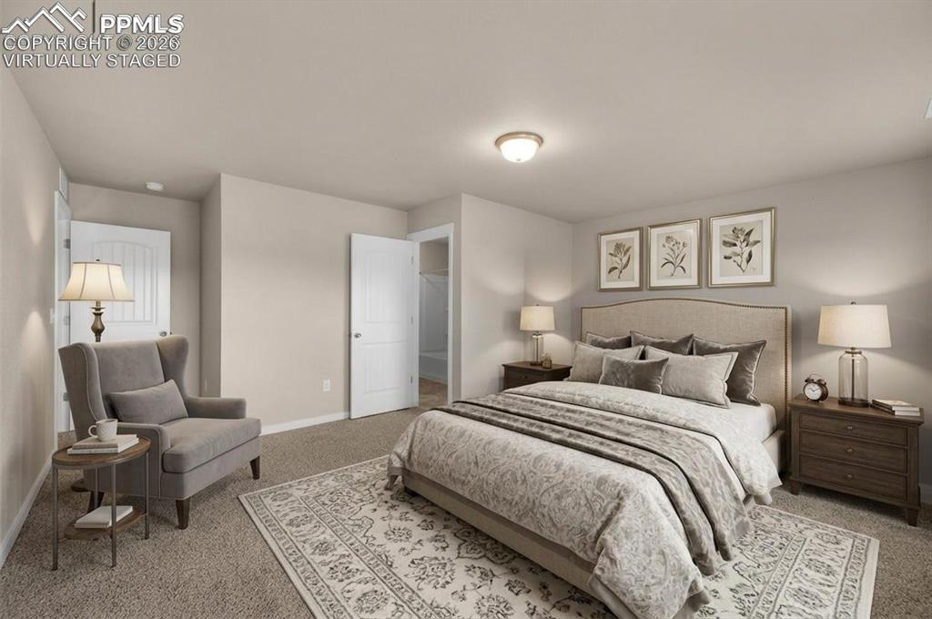 6684 Rawhide Rdg View Colorado Springs, CO 80915 - Photo 21 of 37 a bedroom with a bed and wooden floor