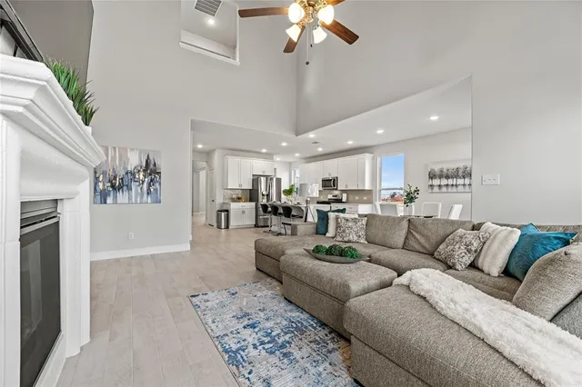 a living room with furniture and a chandelier
