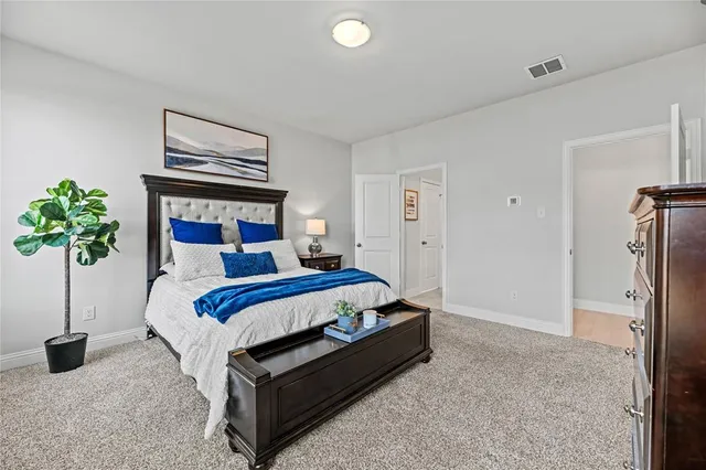 a bedroom with a bed and a potted plant