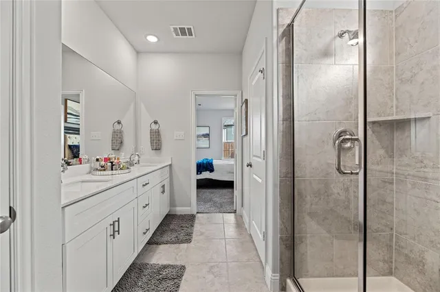 a bathroom with a double vanity sink and mirror