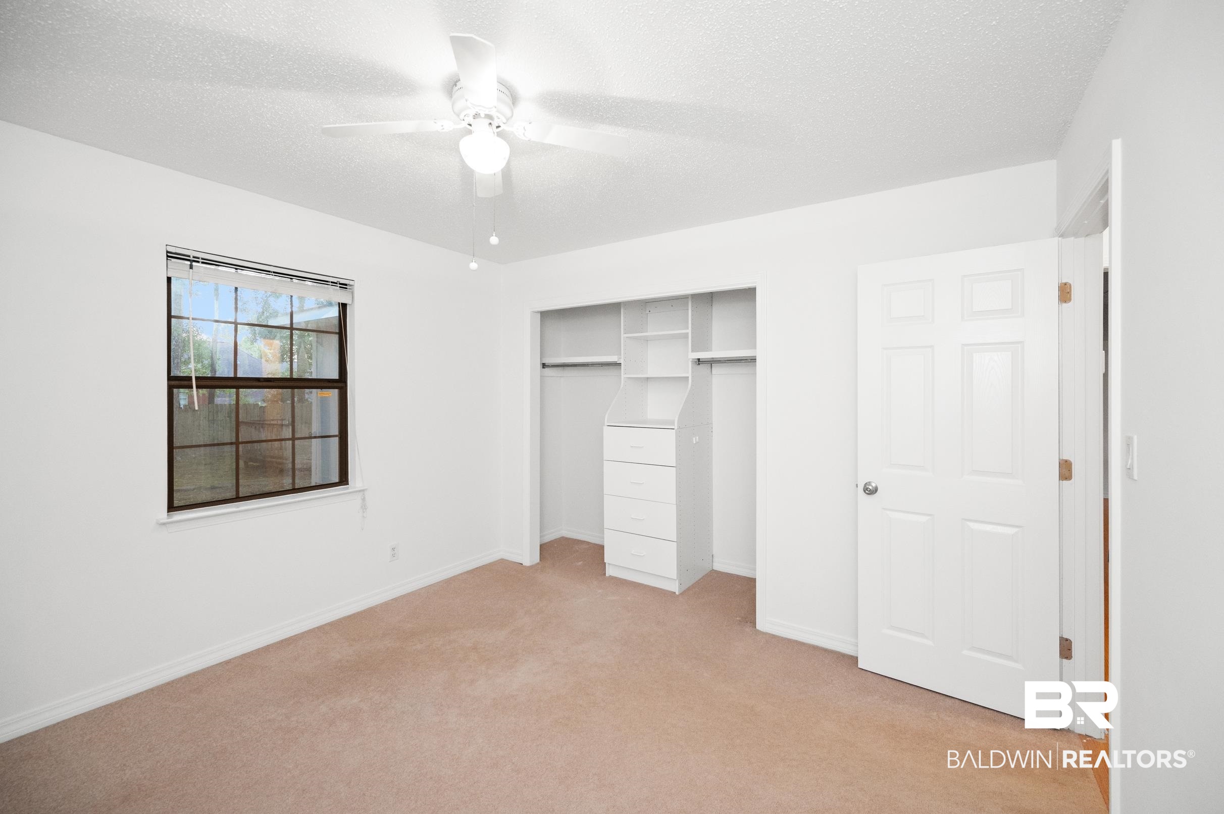 128 Dunbar Loop Daphne, AL 36526 - Photo 19 of 39 Unfurnished bedroom with light carpet, a textured ceiling, ceiling fan, and a closet