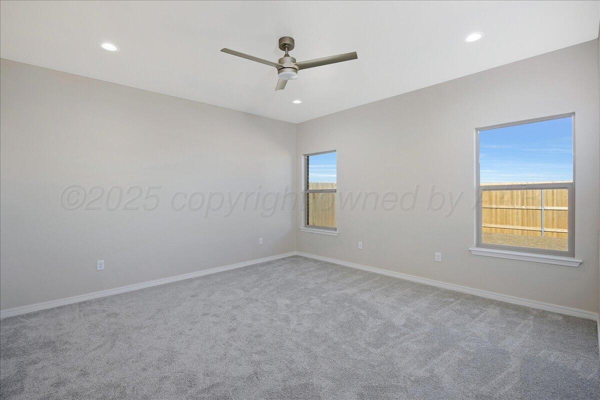 4302 Beacon Road Amarillo, TX 79118 - Photo 10 of 20 en empty room with window and ceiling fan