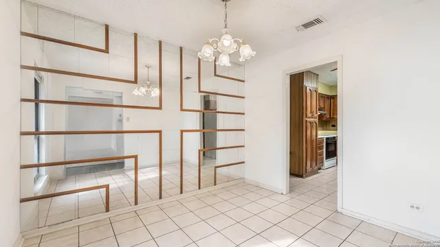 a view of a hallway with chandelier and entryway