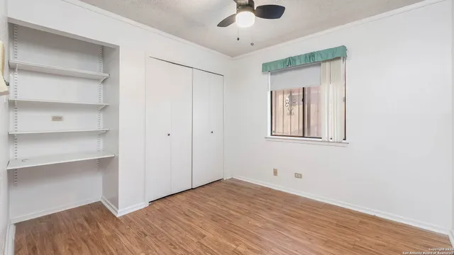 a view of empty room with wooden floor