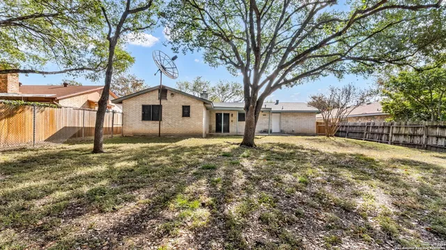 a white house that has a tree in front of it