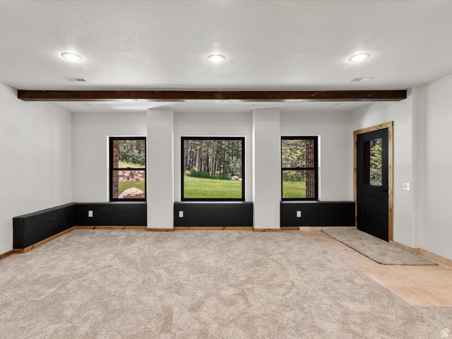 1225 Old Oregon Road Soda Springs, ID 83276 - Photo 30 of 67 Spacious interior room featuring light-toned carpet, recessed lighting, and exposed wood beam accents