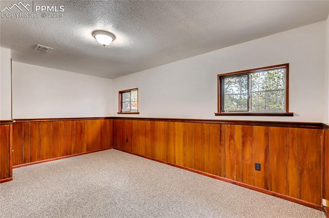 91 Alpine Road Woodland Park, CO 80863 - Photo 20 of 36 The second bedroom of the main house is also on the main level. Closet is cedar-lined.