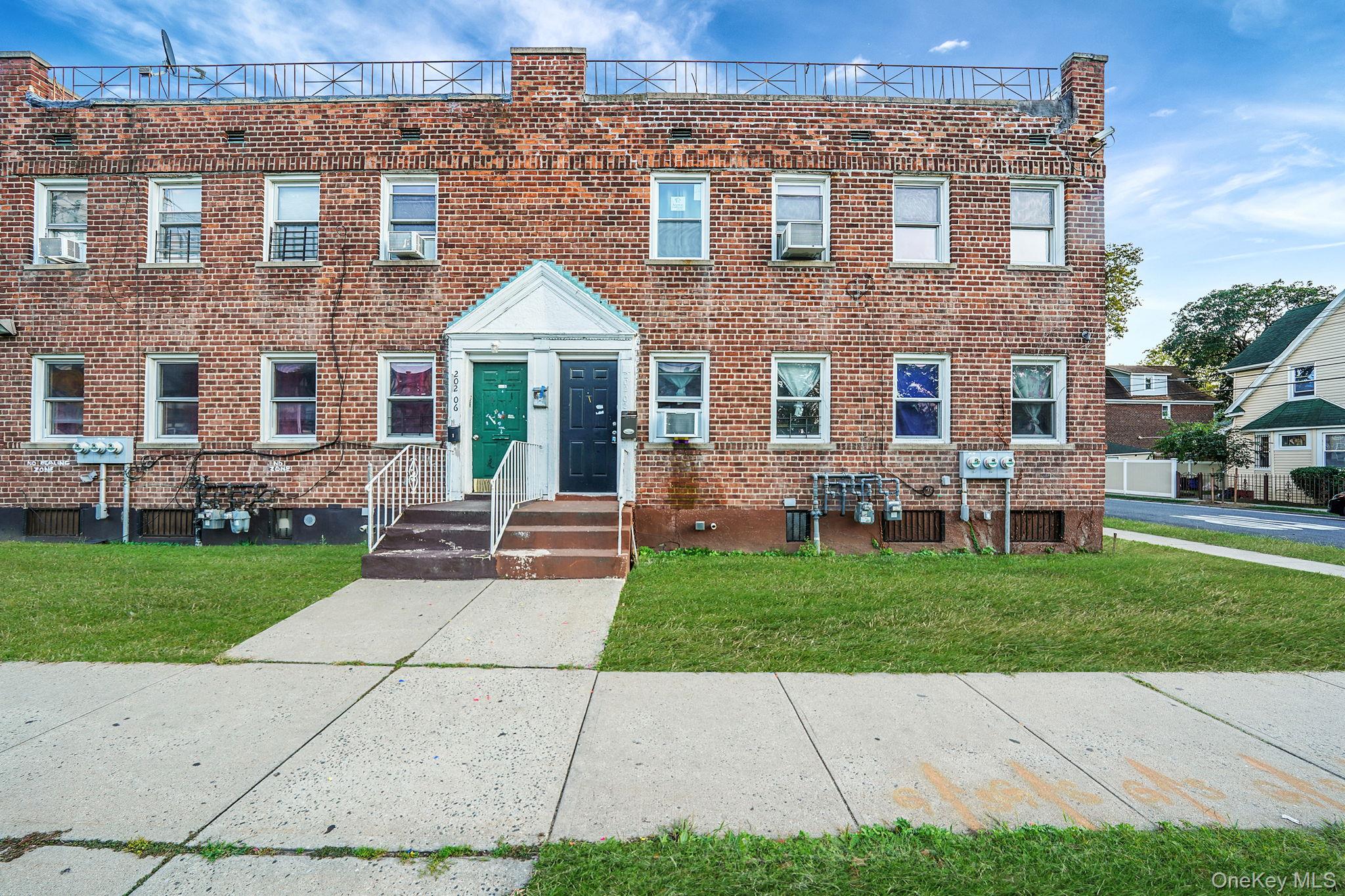 View of front of home featuring a front lawn and brick siding