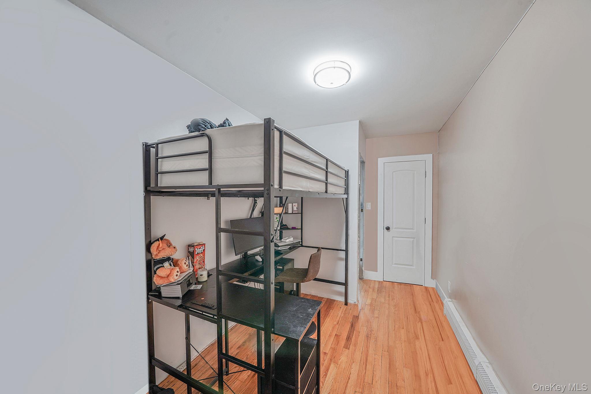 202-02 109th Avenue Queens, NY 11412 - Photo 18 of 26 Bedroom with light wood-style flooring and a baseboard heating unit