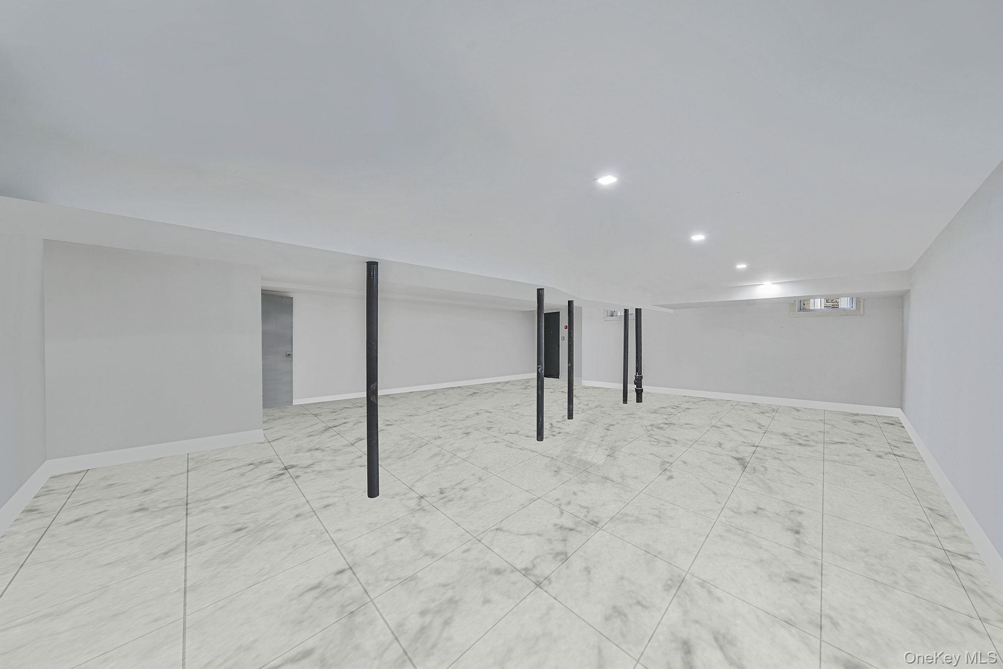 202-02 109th Avenue Queens, NY 11412 - Photo 24 of 26 Finished basement with baseboards and recessed lighting