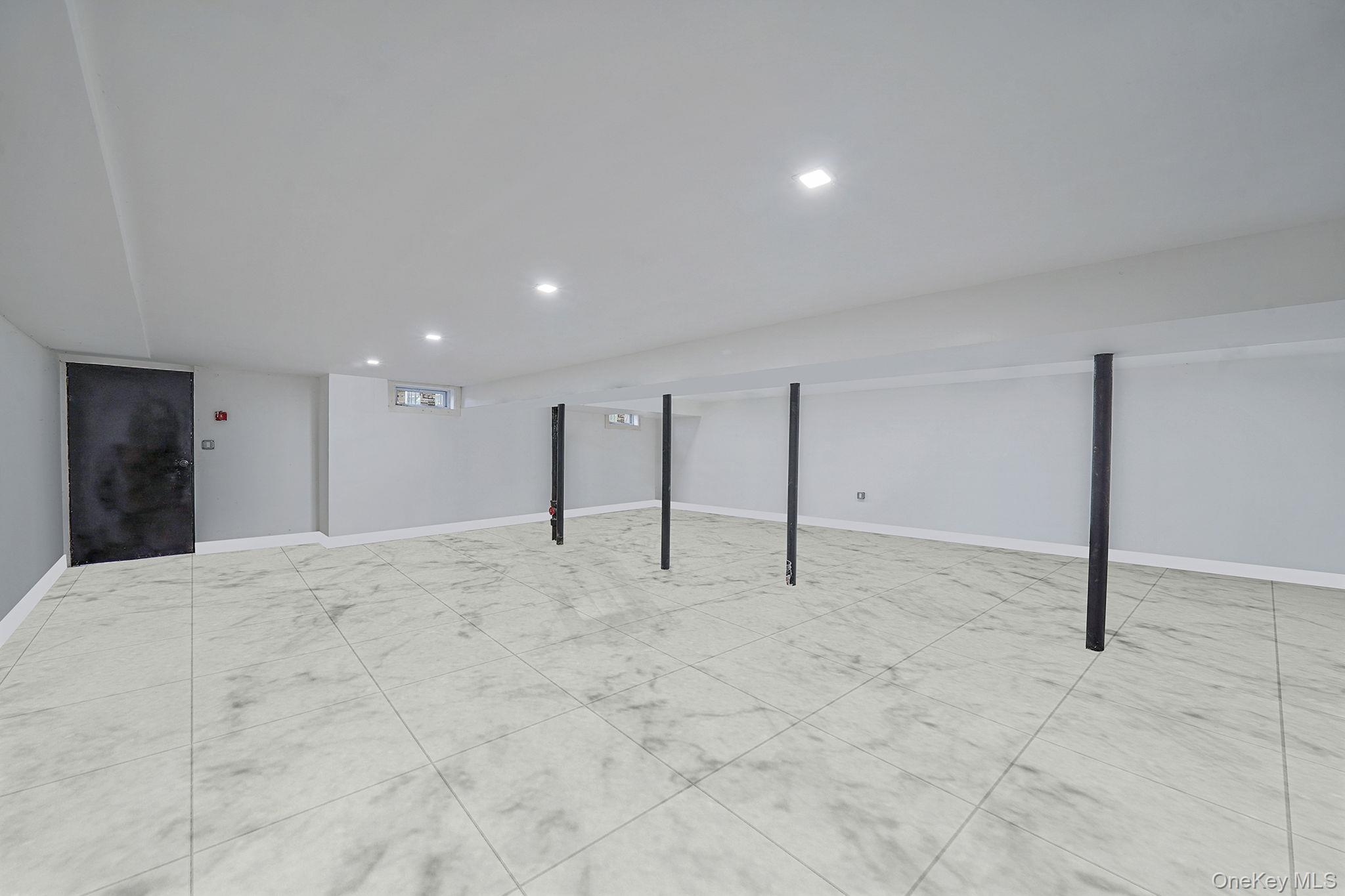 202-02 109th Avenue Queens, NY 11412 - Photo 25 of 26 Finished below grade area with baseboards and recessed lighting