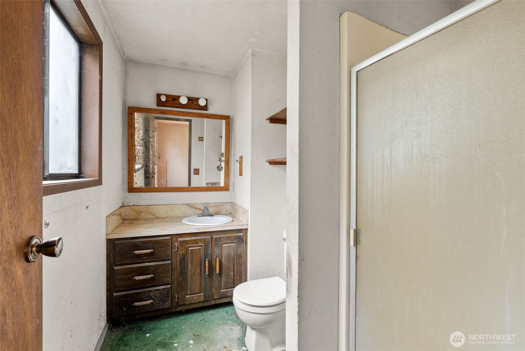 626 Ostman Road Raymond, WA 98577 - Photo 12 of 29 a bathroom with a granite countertop toilet sink and a mirror