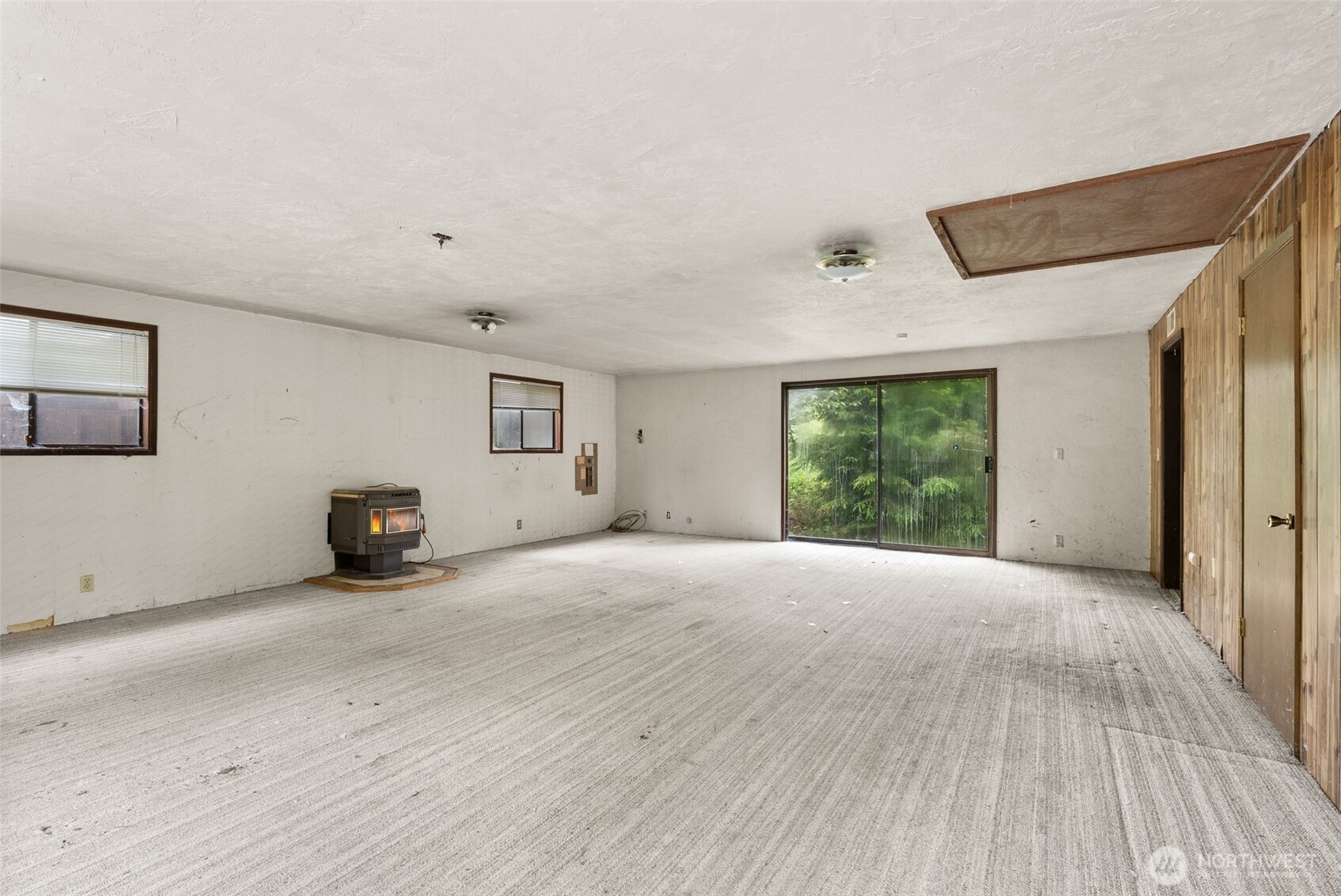 626 Ostman Road Raymond, WA 98577 - Photo 9 of 29 a view of an empty room with wooden floor and a window