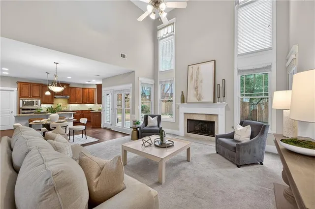 a living room with furniture fireplace and a large window