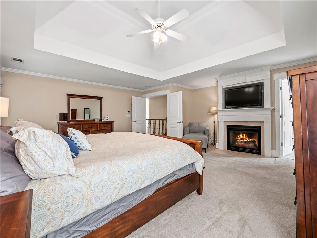 453 Hunter Street Northwest Norcross, GA 30071 - Photo 11 of 36 a bed room with a bed and a flat screen tv