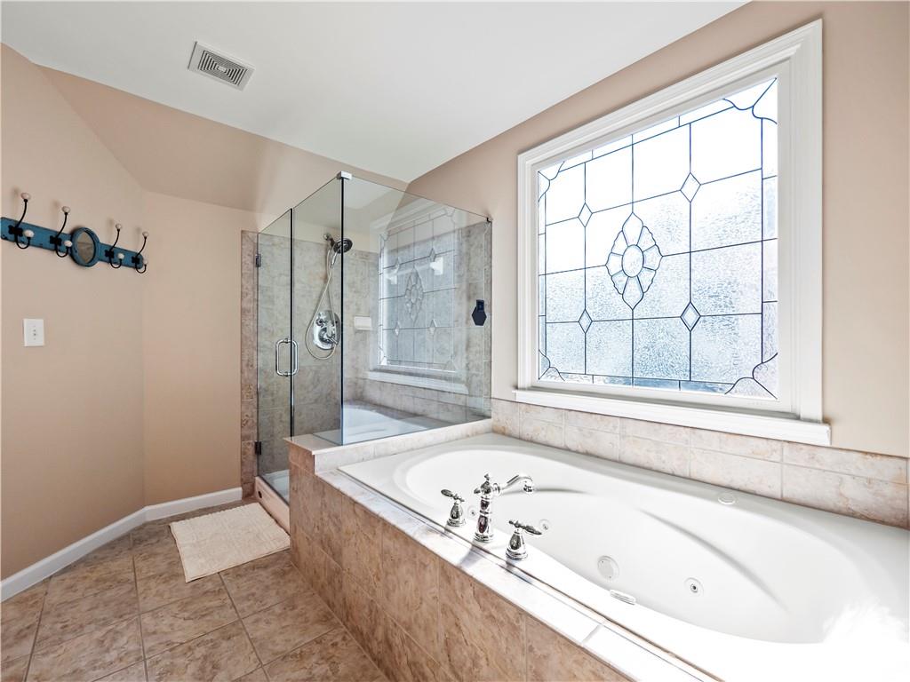 453 Hunter Street Northwest Norcross, GA 30071 - Photo 12 of 36 a bathroom with a tub a sink and a window