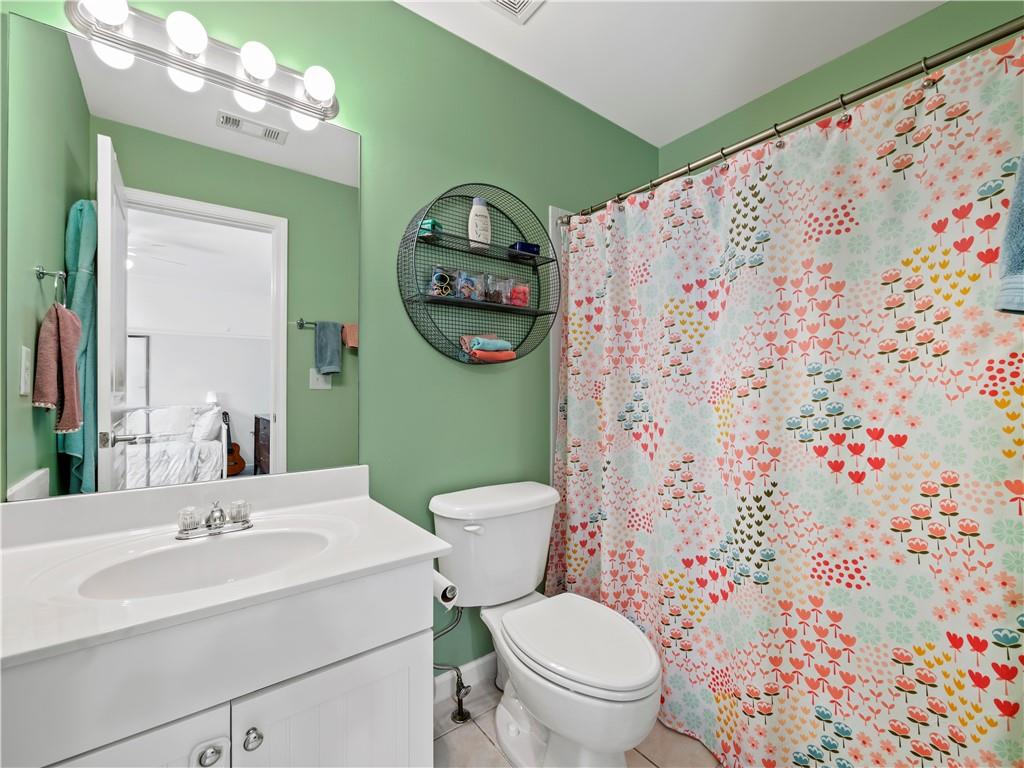 453 Hunter Street Northwest Norcross, GA 30071 - Photo 14 of 36 a bathroom with a toilet sink vanity and mirror